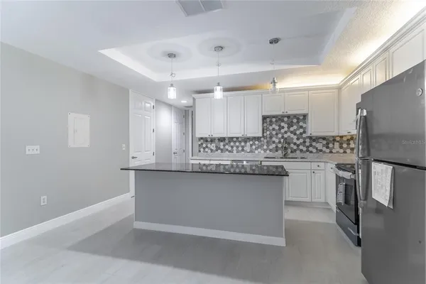 a kitchen with granite countertop a sink and stainless steel appliances