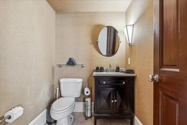 a bathroom with a toilet a sink and mirror