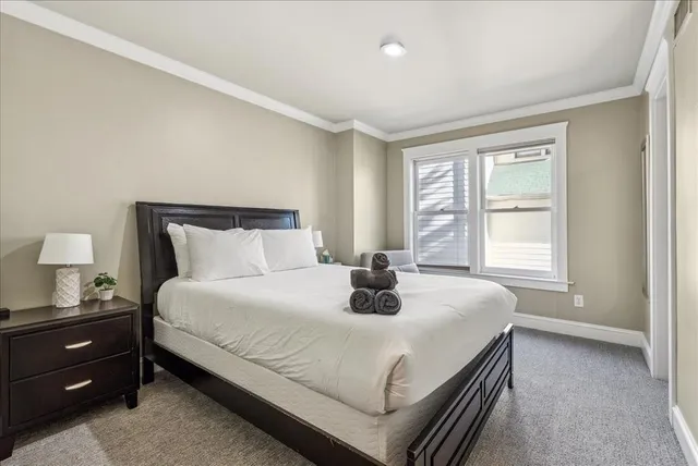 a bedroom with a bed and window