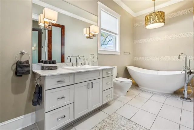 a bathroom with a double vanity sink mirror and bathtub