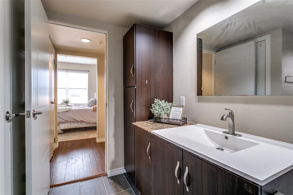 1100 West Trinity Mills Road, Unit 3005 Carrollton, TX 75006 - Photo 11 of 15 a en suite bathroom with a sink and mirror