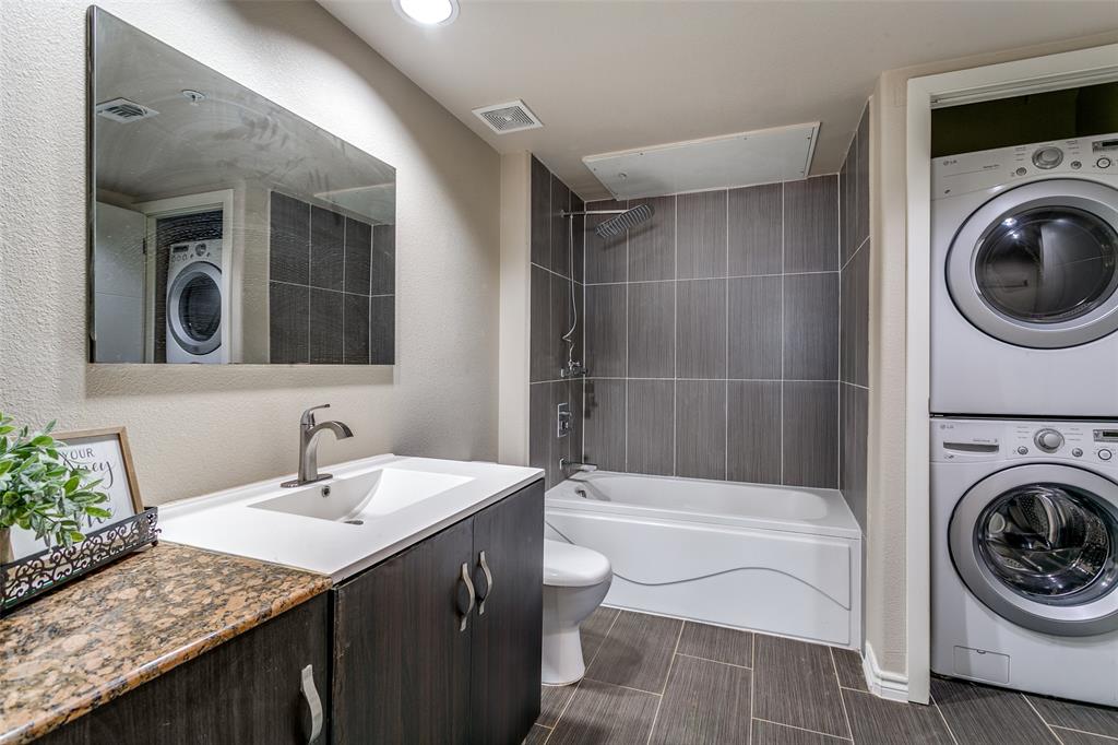 1100 West Trinity Mills Road, Unit 3005 Carrollton, TX 75006 - Photo 12 of 15 a bathroom with a sink a toilet and a mirror