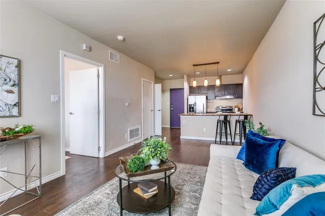 a living room with furniture and a potted plant