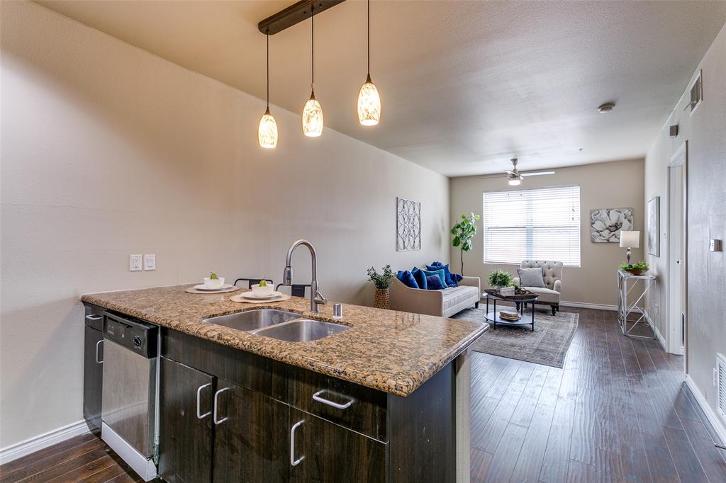 1100 West Trinity Mills Road, Unit 3005 Carrollton, TX 75006 - Photo 7 of 15 a kitchen with a table chairs and wooden floor