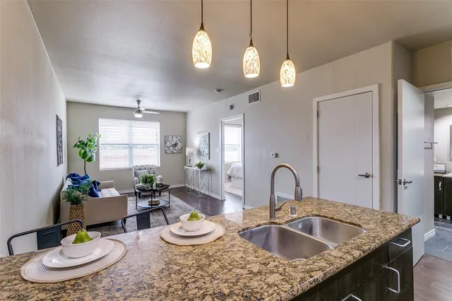 a kitchen with a granite countertop sink and a granite counter top