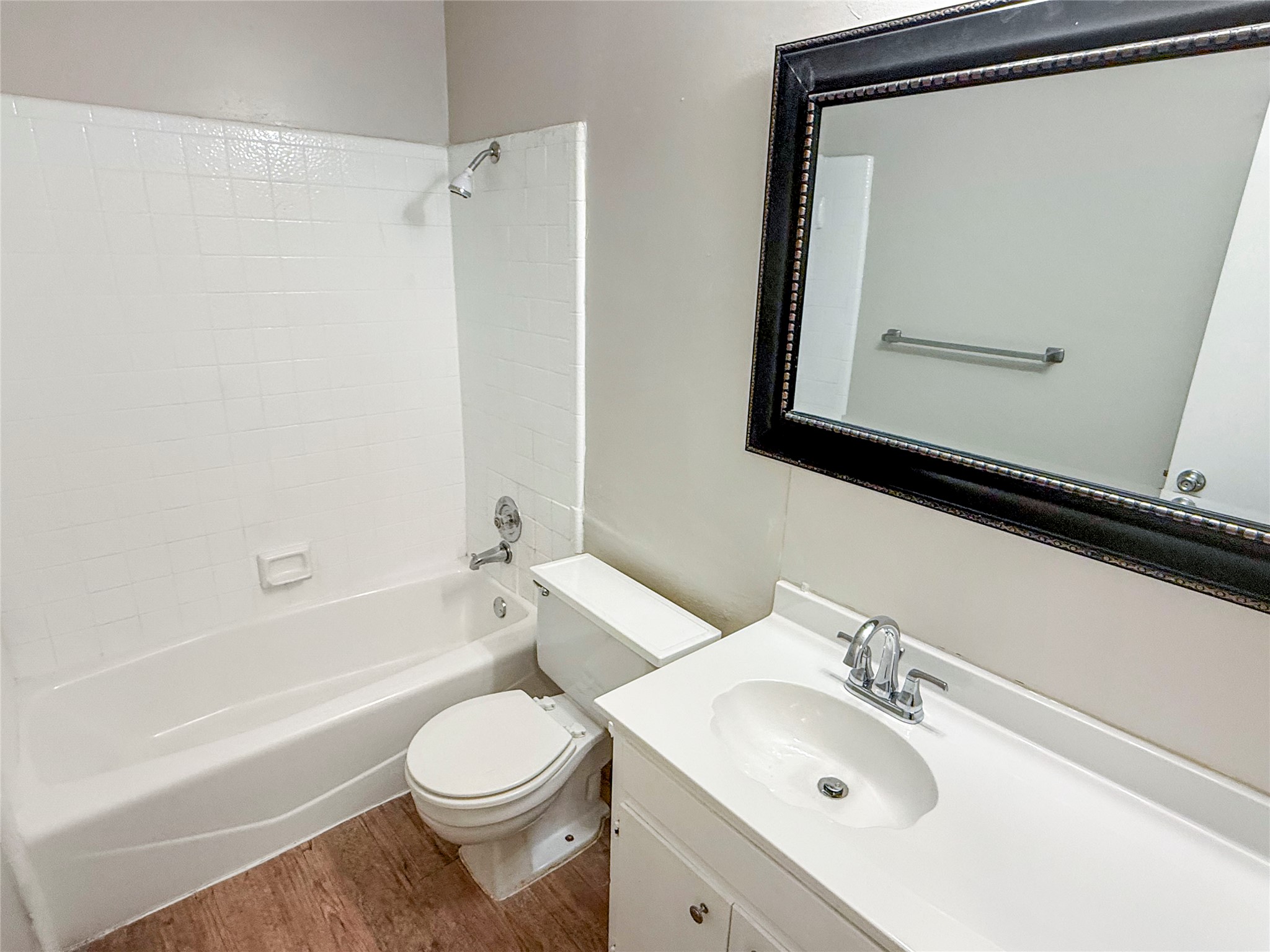 409 Rawhide Loop Round Rock, TX 78681 - Photo 8 of 14 Bathroom featuring a white vanity with integrated sink, chrome faucet, and a large framed mirror