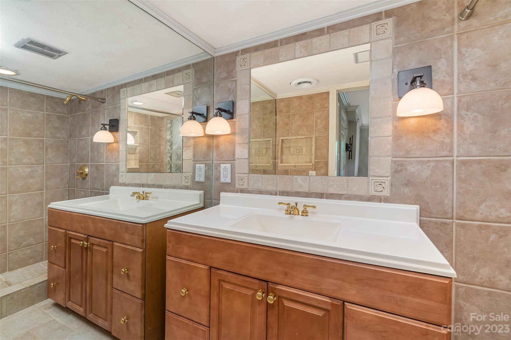 6745 Alanbrook Road Charlotte, NC 28215 - Photo 12 of 28 a bathroom with a sink and a mirror