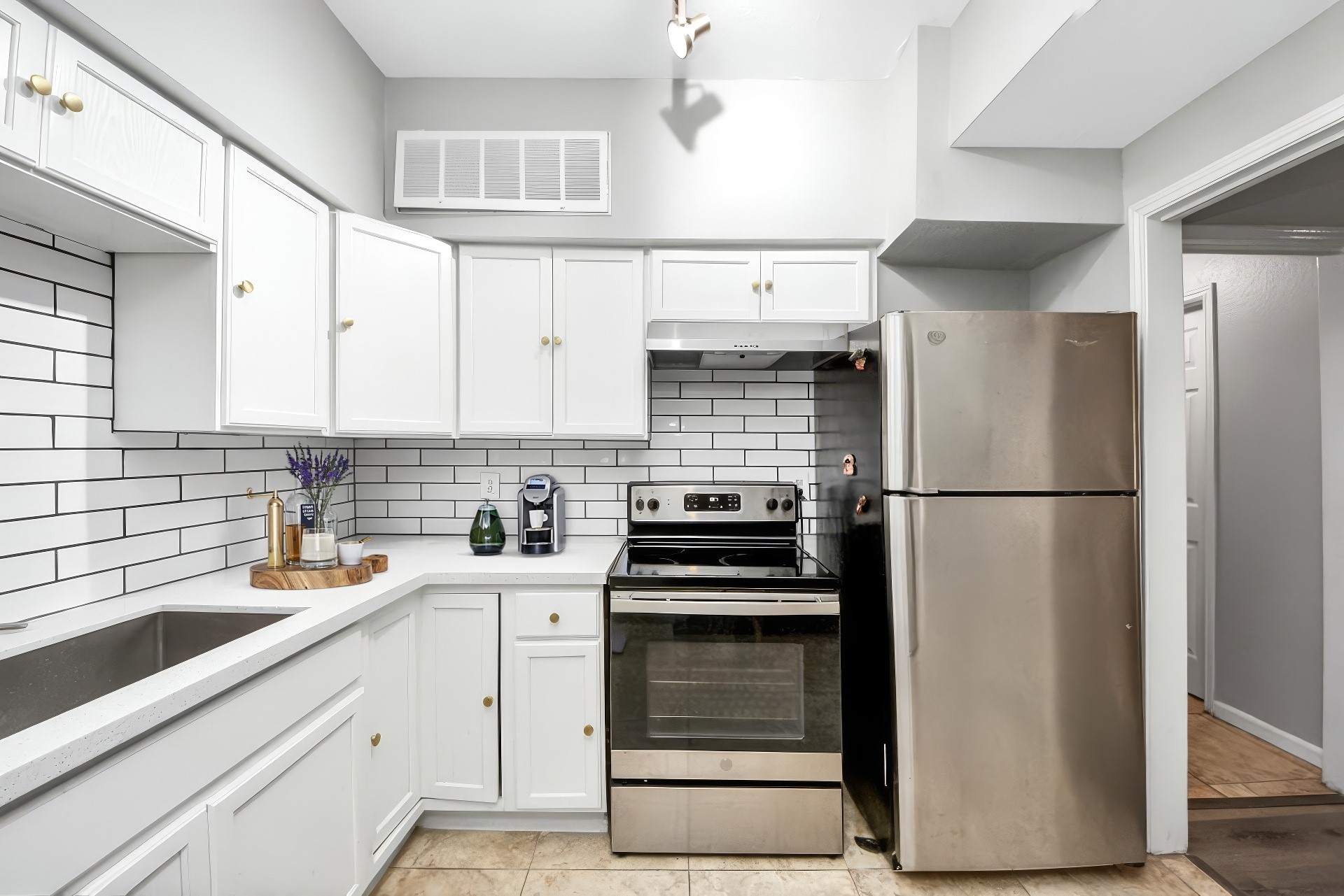 2100 Tanglewilde Street, Unit 312 Houston, TX 77063 - Photo 4 of 11 a kitchen with a refrigerator sink and cabinets