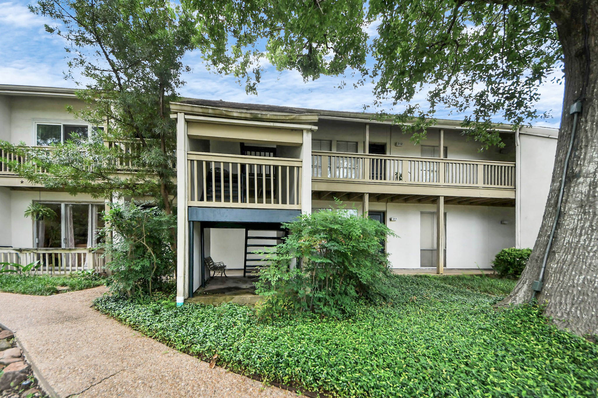2100 Tanglewilde Street, Unit 312 Houston, TX 77063 - Photo 8 of 11 a front view of a house with garden