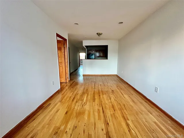 a view of a room with wooden floor