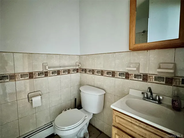 a bathroom with a sink a toilet and mirror