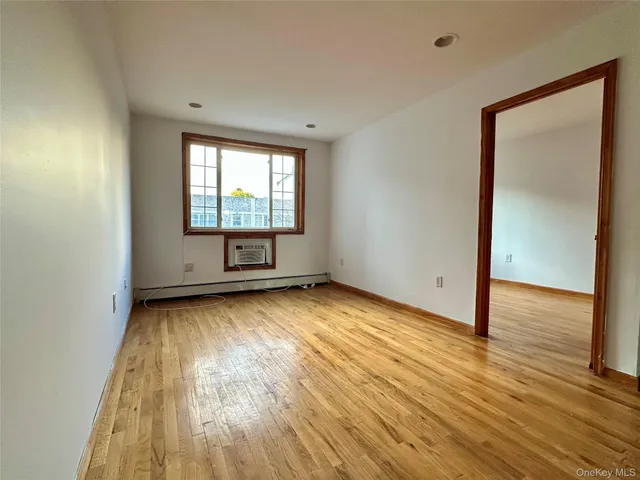 a view of a room with wooden floor and window
