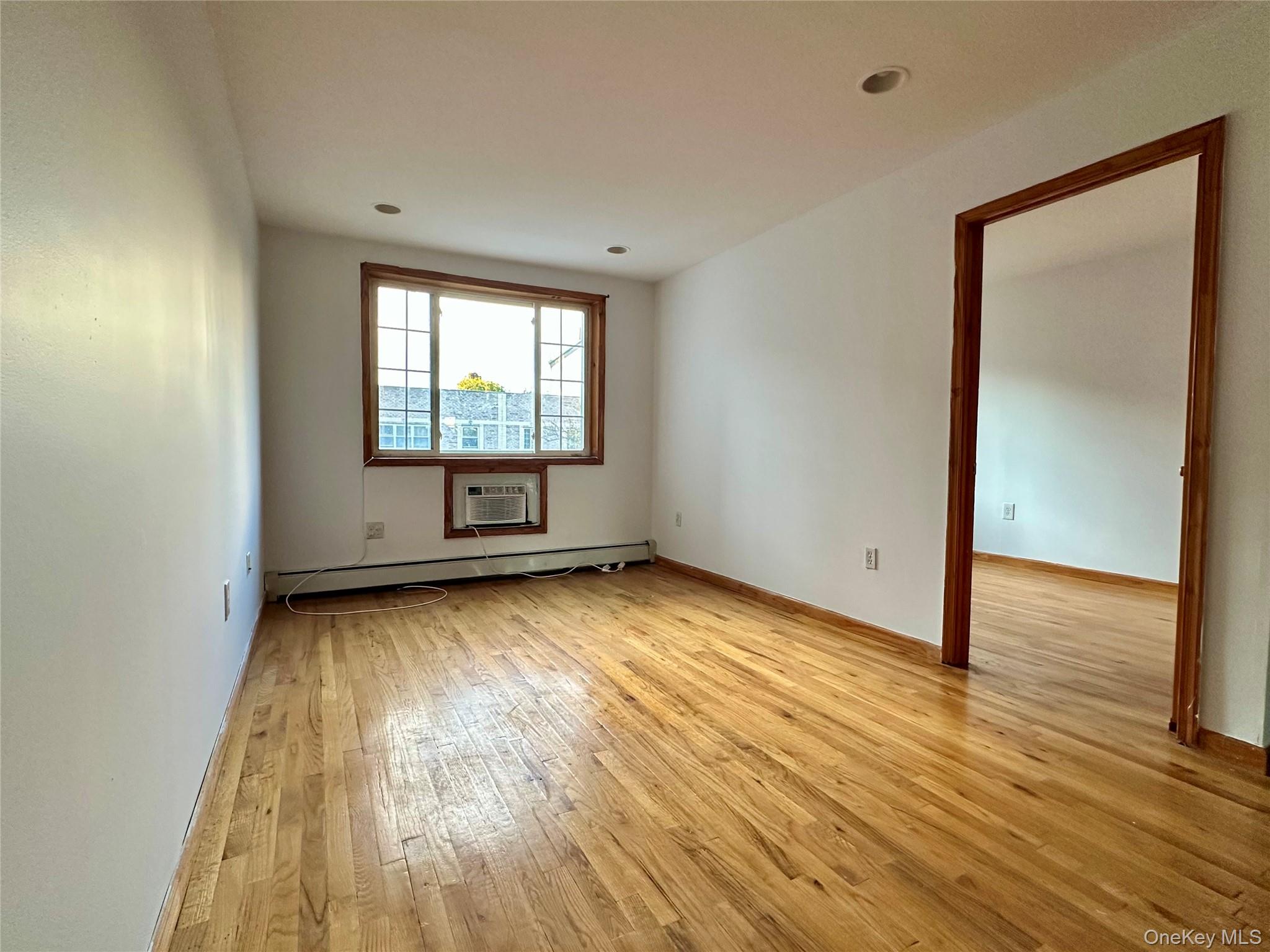 22 Jefferson Street, Unit 3 Brooklyn, NY 11206 - Photo 6 of 12 a view of a room with wooden floor and window