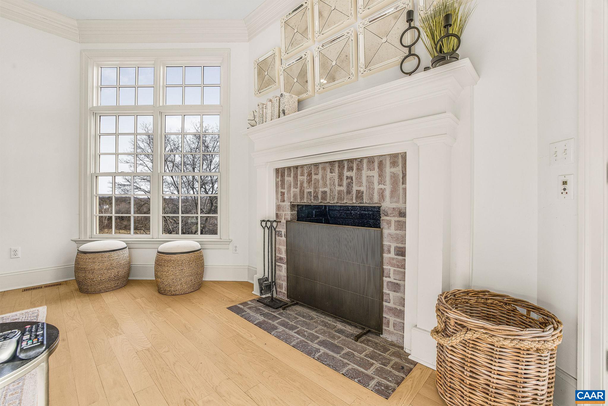 0 Ragged Mountain Drive Charlottesville, VA 22903 - Photo 18 of 70 a living room with a fireplace and a window