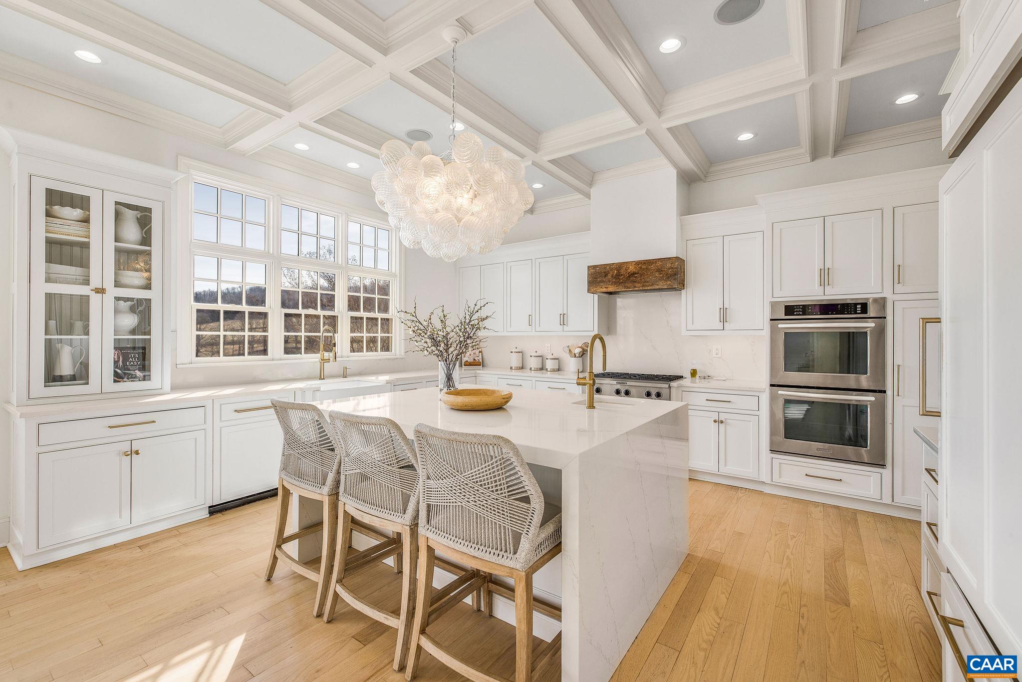 0 Ragged Mountain Drive Charlottesville, VA 22903 - Photo 24 of 70 a kitchen with stainless steel appliances kitchen island granite countertop a stove a refrigerator a sink a dining table and chairs with wooden floor