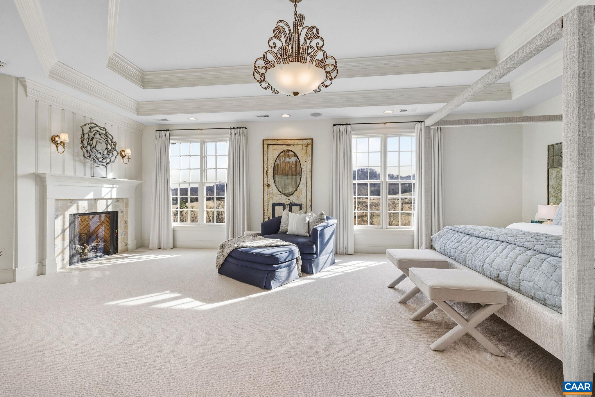 0 Ragged Mountain Drive Charlottesville, VA 22903 - Photo 40 of 70 a spacious bedroom with a bed a chandelier and a large window