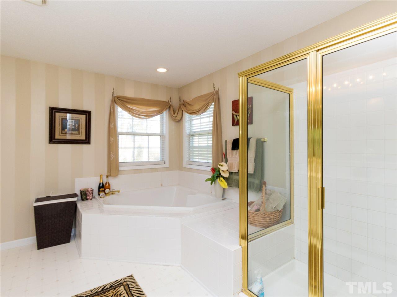2500 Bulmer Terrace Raleigh, NC 27615 - Photo 13 of 25 a spacious bathroom with a bathtub and a shower