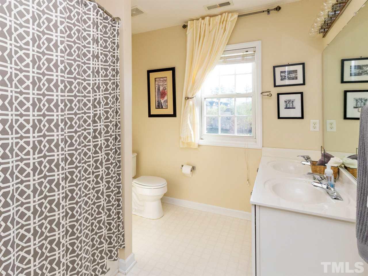 2500 Bulmer Terrace Raleigh, NC 27615 - Photo 17 of 25 a bathroom with a sink a toilet and window
