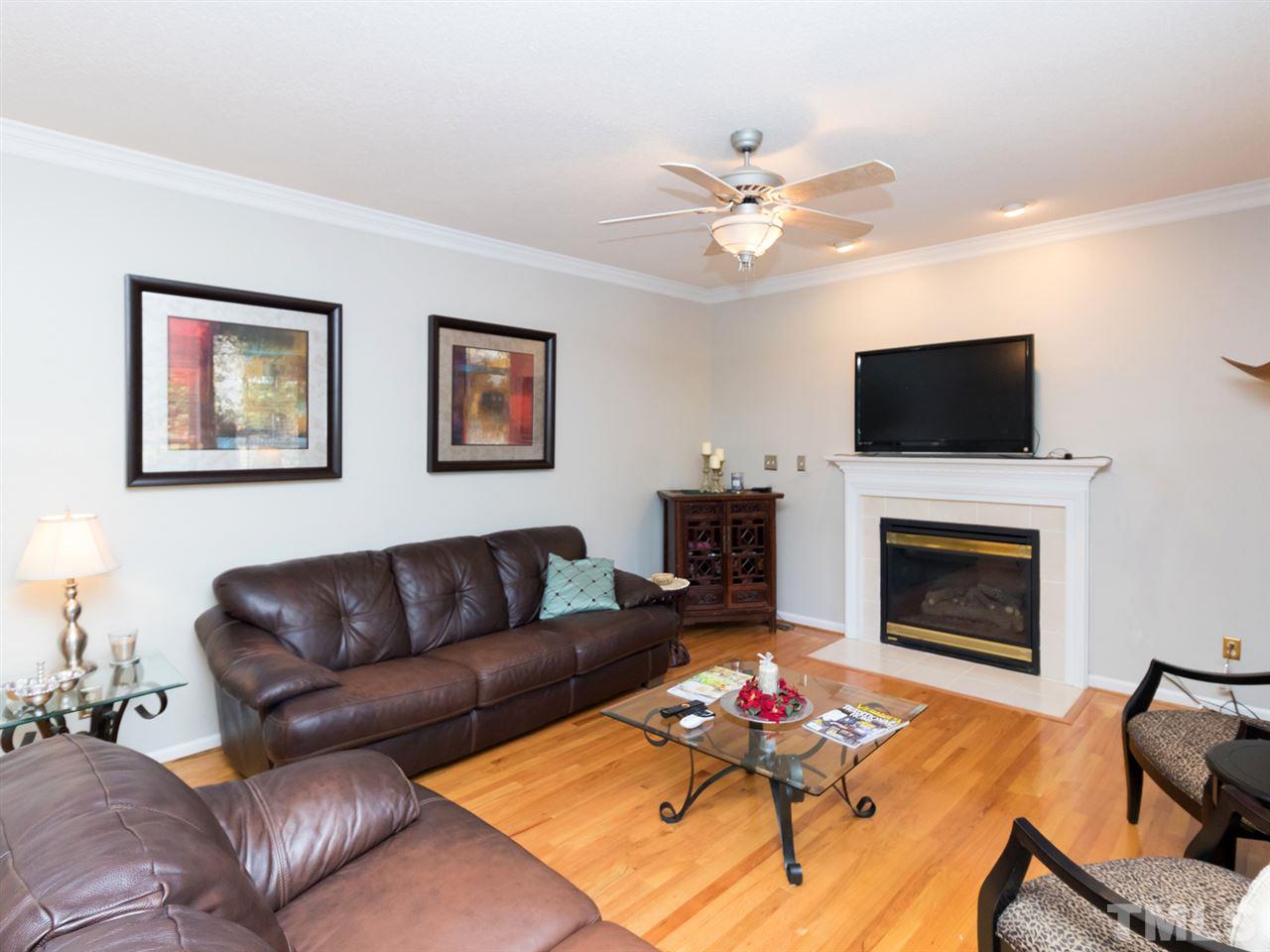 2500 Bulmer Terrace Raleigh, NC 27615 - Photo 4 of 25 a living room with furniture a fireplace and a flat screen tv