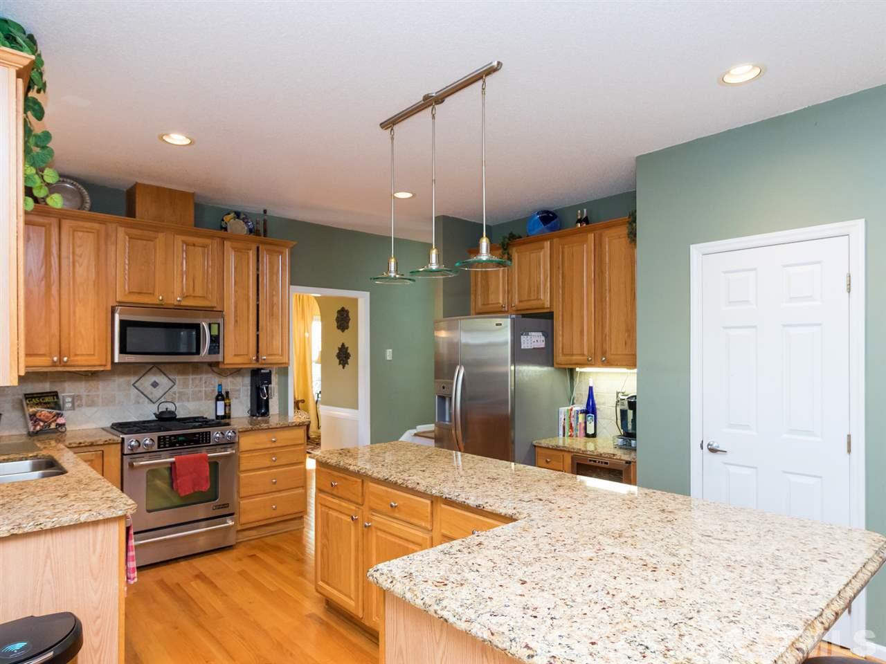 2500 Bulmer Terrace Raleigh, NC 27615 - Photo 6 of 25 a kitchen with granite countertop a refrigerator and a sink