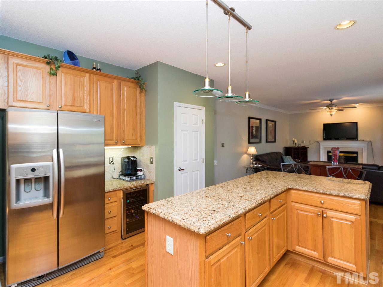 2500 Bulmer Terrace Raleigh, NC 27615 - Photo 8 of 25 a kitchen with stainless steel appliances kitchen island granite countertop a refrigerator a oven a sink with island and chairs