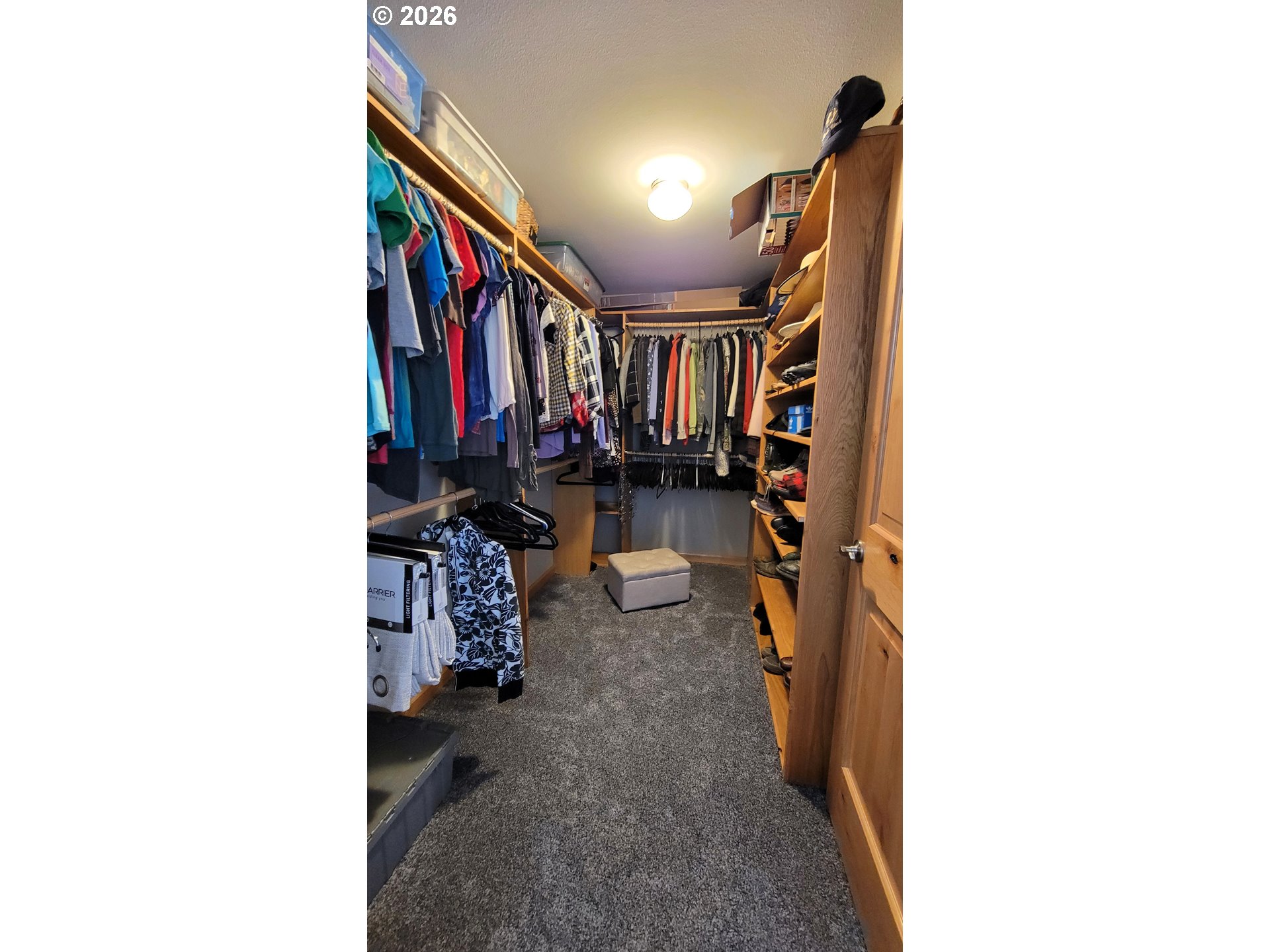 24674 Bolton Hill Road Veneta, OR 97487 - Photo 16 of 35 a view of walk in closet with clothes and shoes