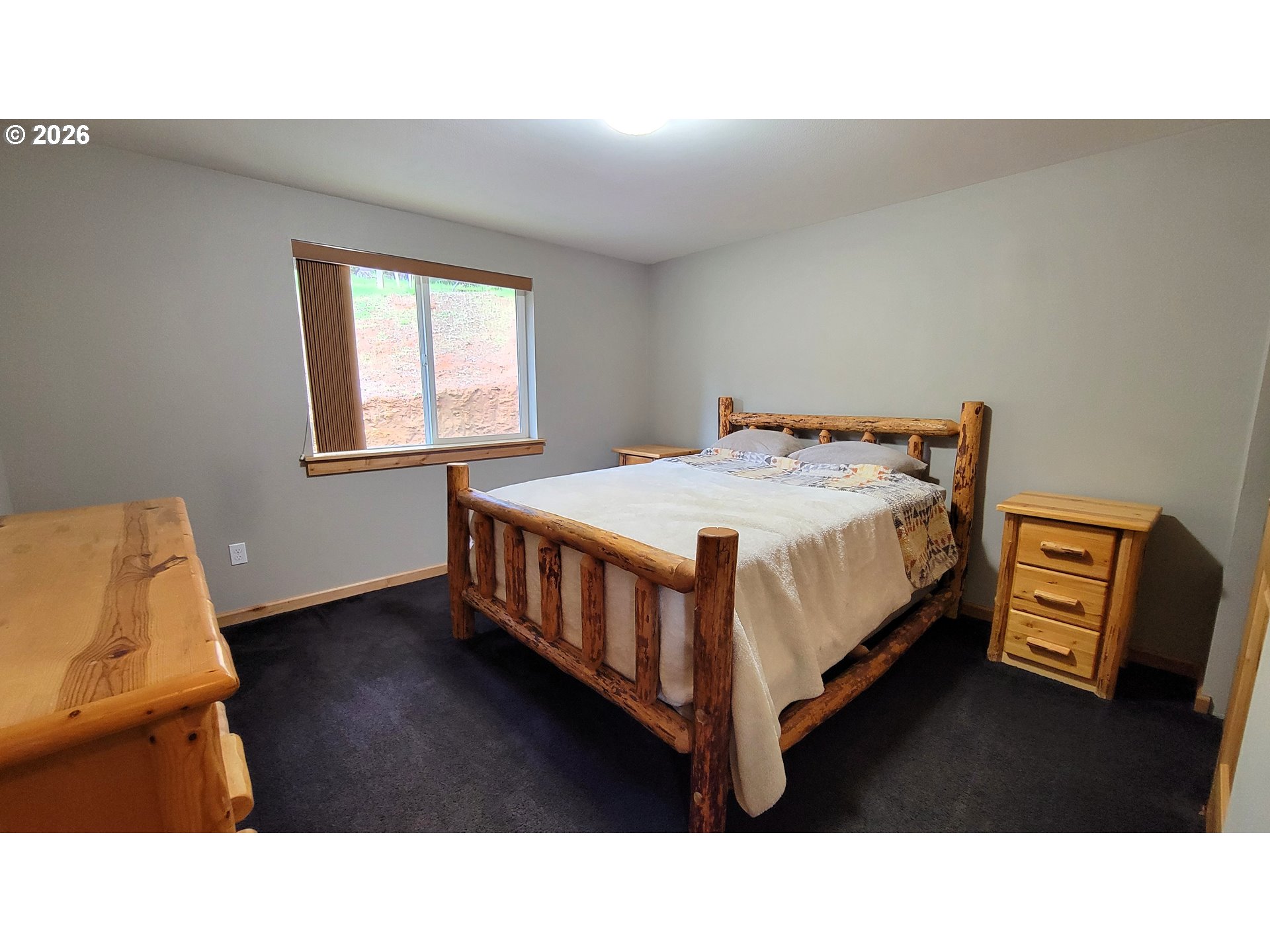 24674 Bolton Hill Road Veneta, OR 97487 - Photo 19 of 35 a living room with a bed furniture and a window