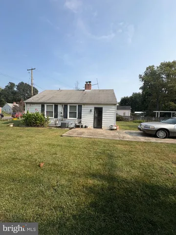 a front view of a house with swimming pool having outdoor seating