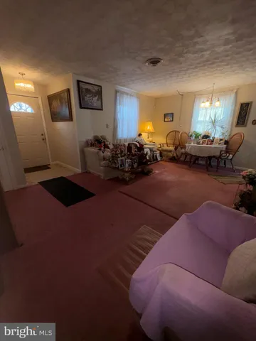 a living room with furniture a window and gym equipment