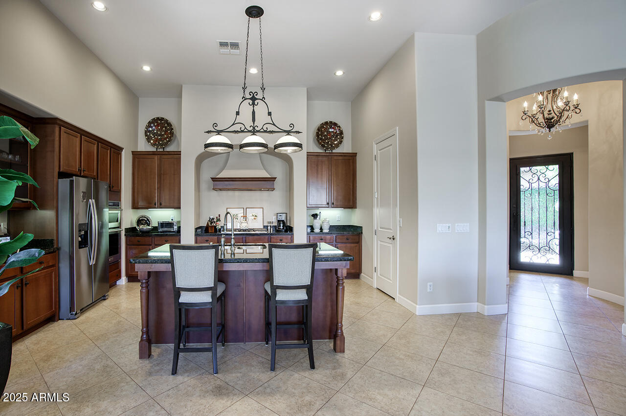 9190 East Hoverland Road Scottsdale, AZ 85255 - Photo 12 of 35 a view of a dining room with furniture and chandelier