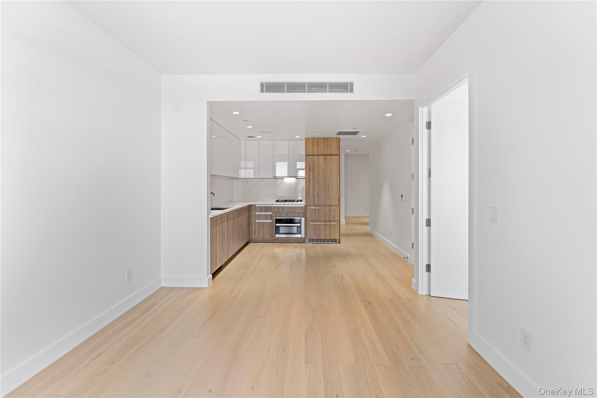 136-18 Maple Avenue, Unit 5G Queens, NY 11355 - Photo 2 of 35 a view of a room with wooden floor