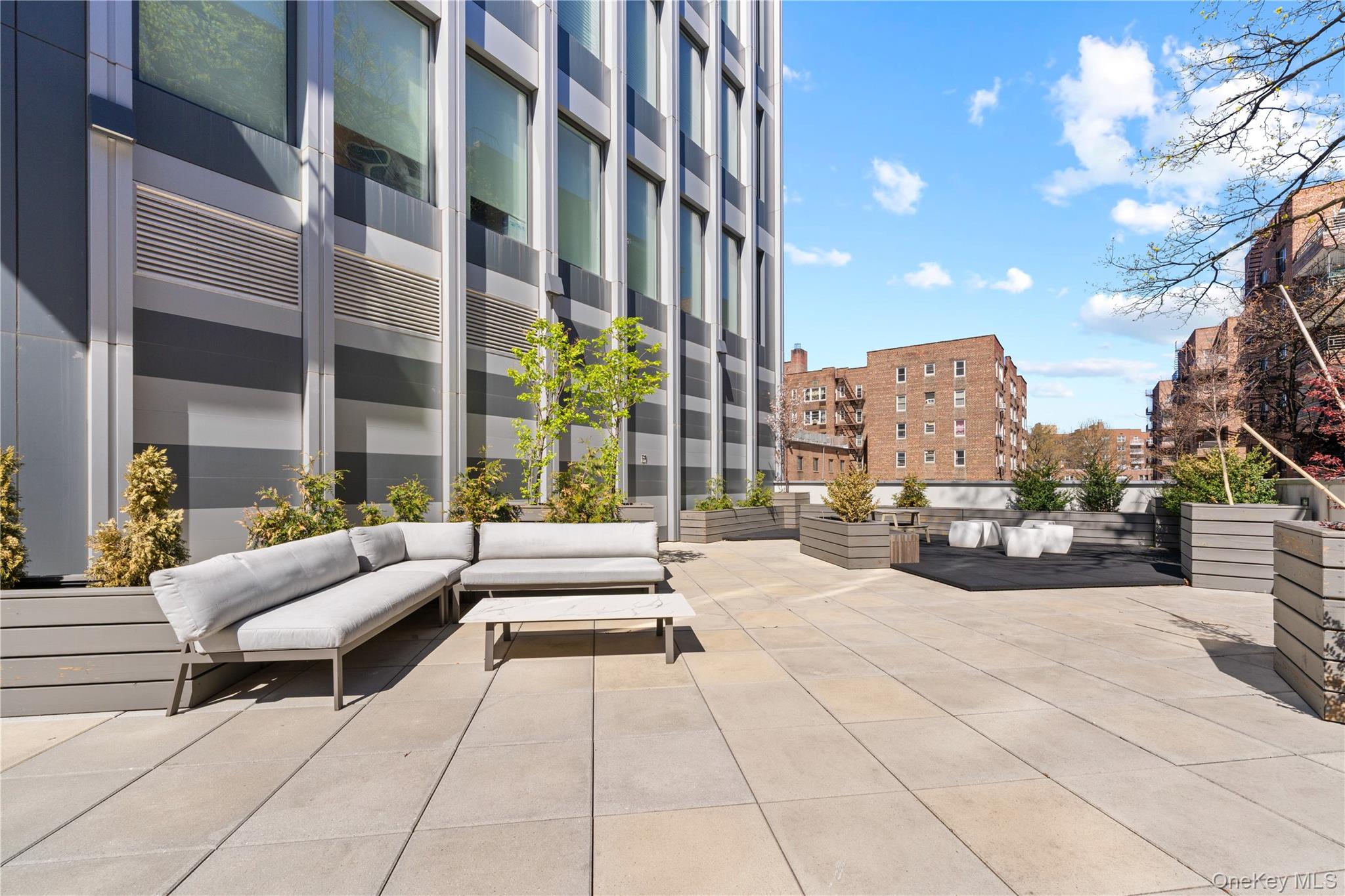 136-18 Maple Avenue, Unit 5G Queens, NY 11355 - Photo 27 of 35 a building outdoor space with patio furniture and a potted plant