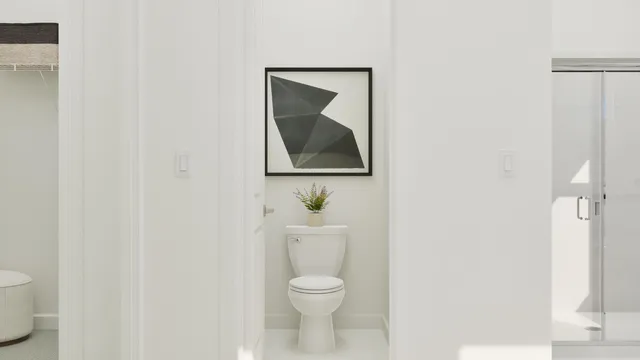 a white toilet sitting next to a white sink and vanity