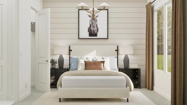 a bedroom with a bed and a painting on the wall