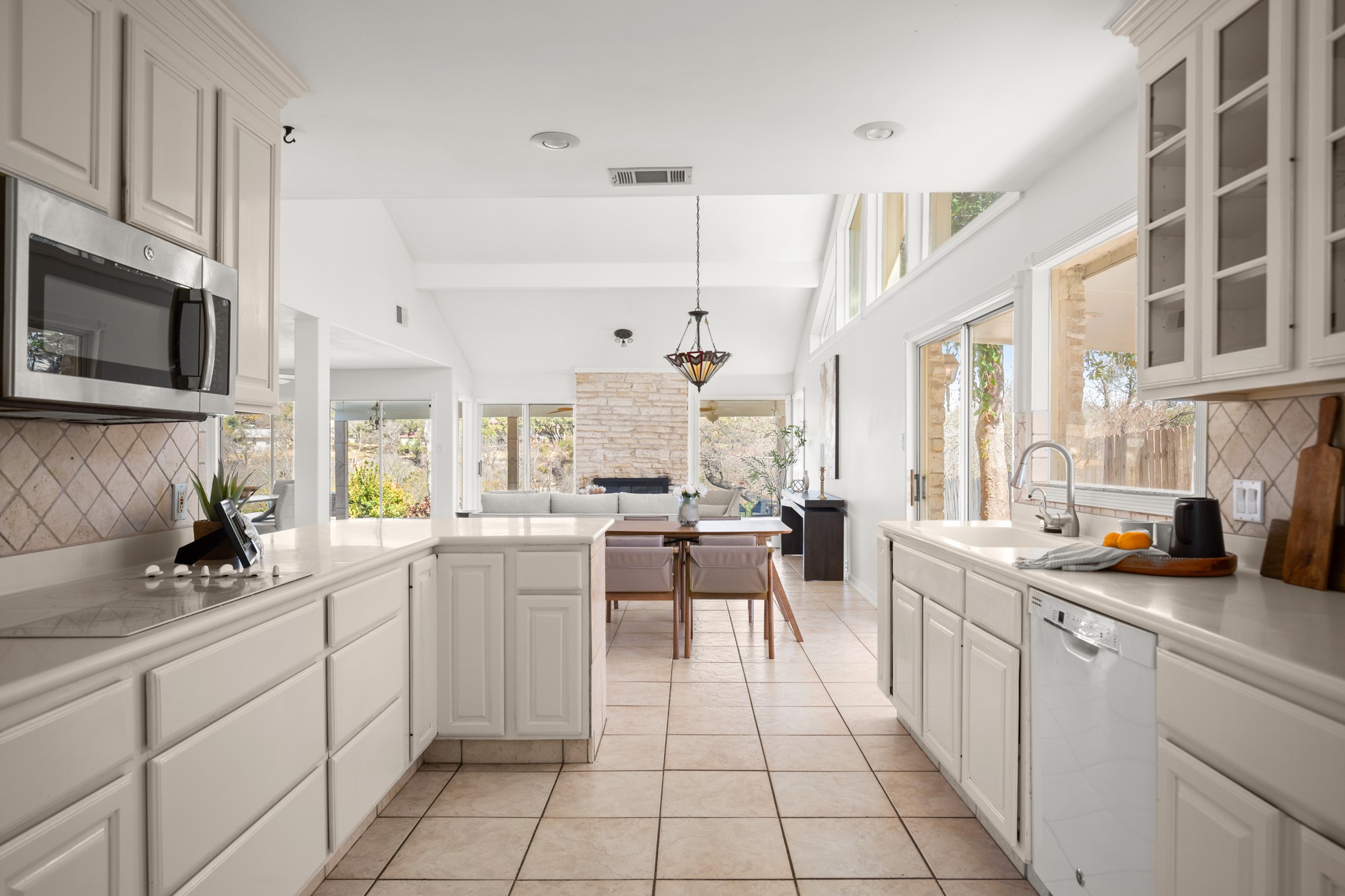 209 Ridgecrest Road Georgetown, TX 78628 - Photo 20 of 40 Featuring corian countertops, built-in appliances including an updated SS microwave, and a garbage disposal.