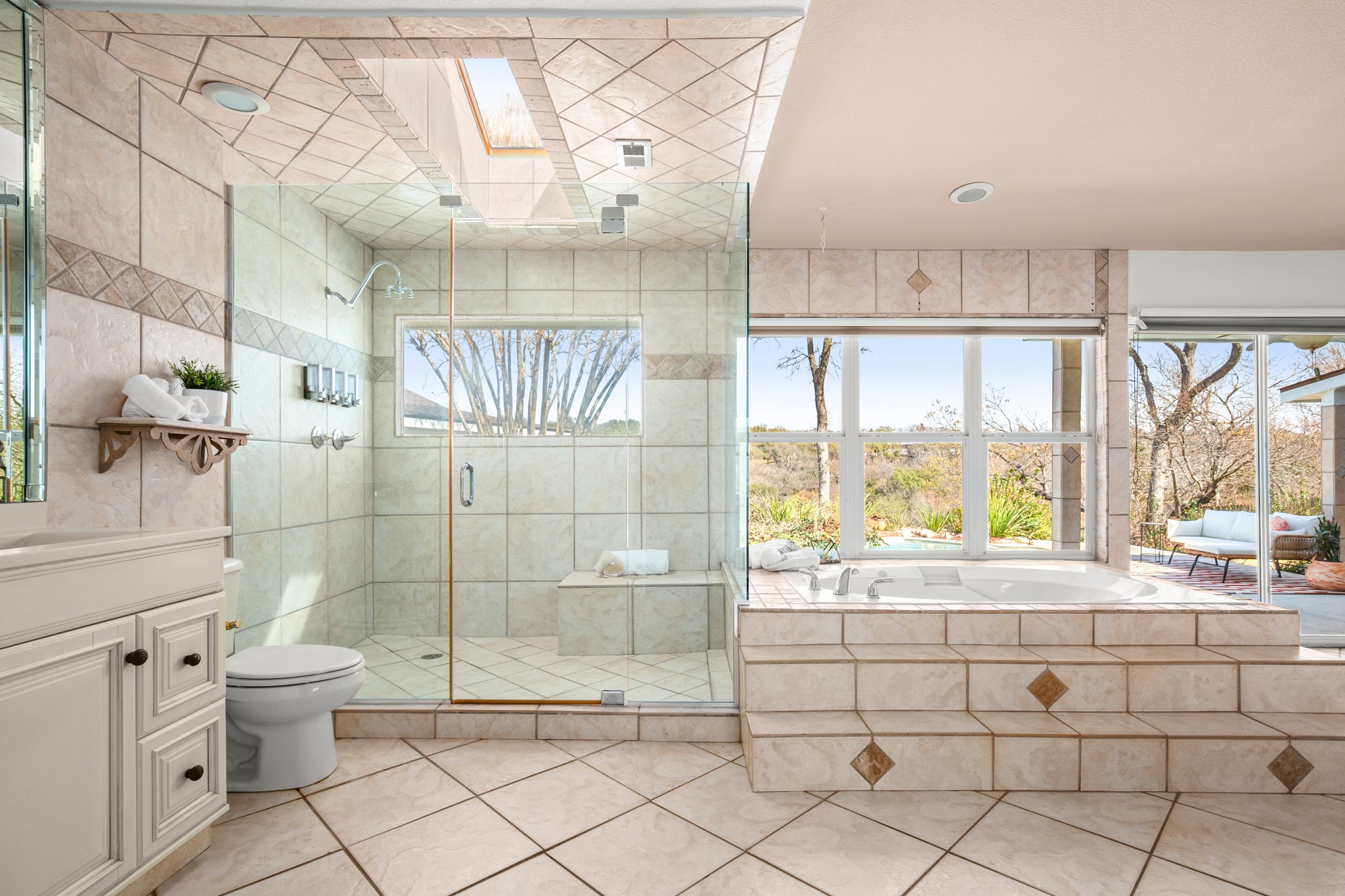 209 Ridgecrest Road Georgetown, TX 78628 - Photo 25 of 40 Gorgeous updated frameless glass walk-in shower with tile surround, bench seating, and a sunlight above.