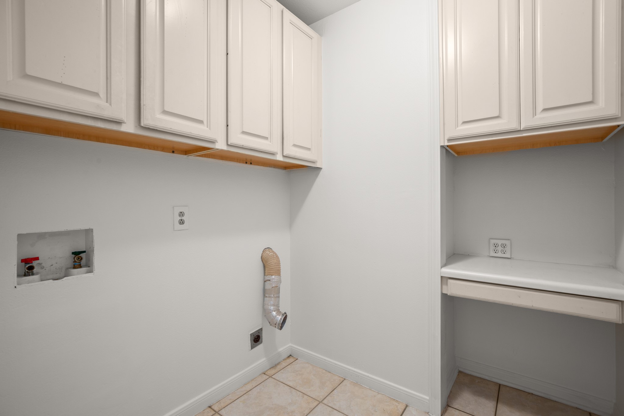 209 Ridgecrest Road Georgetown, TX 78628 - Photo 29 of 40 The main house also offers an in home laundry room with storage cabinetry and a folding vanity.