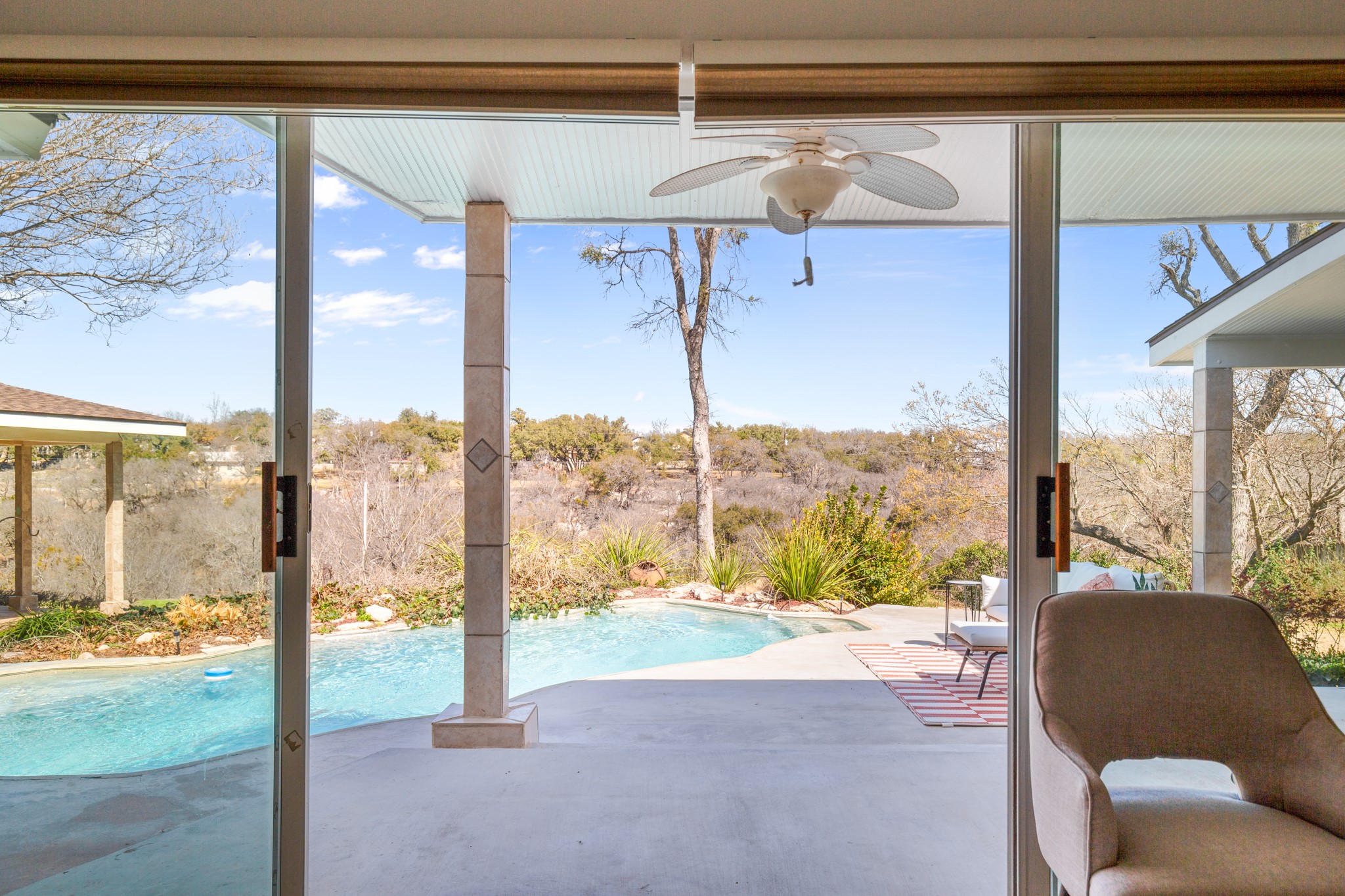 209 Ridgecrest Road Georgetown, TX 78628 - Photo 30 of 40 The addition of four panel glass sliders in the primary bedroom allows you easy access between the pool and your bathroom.