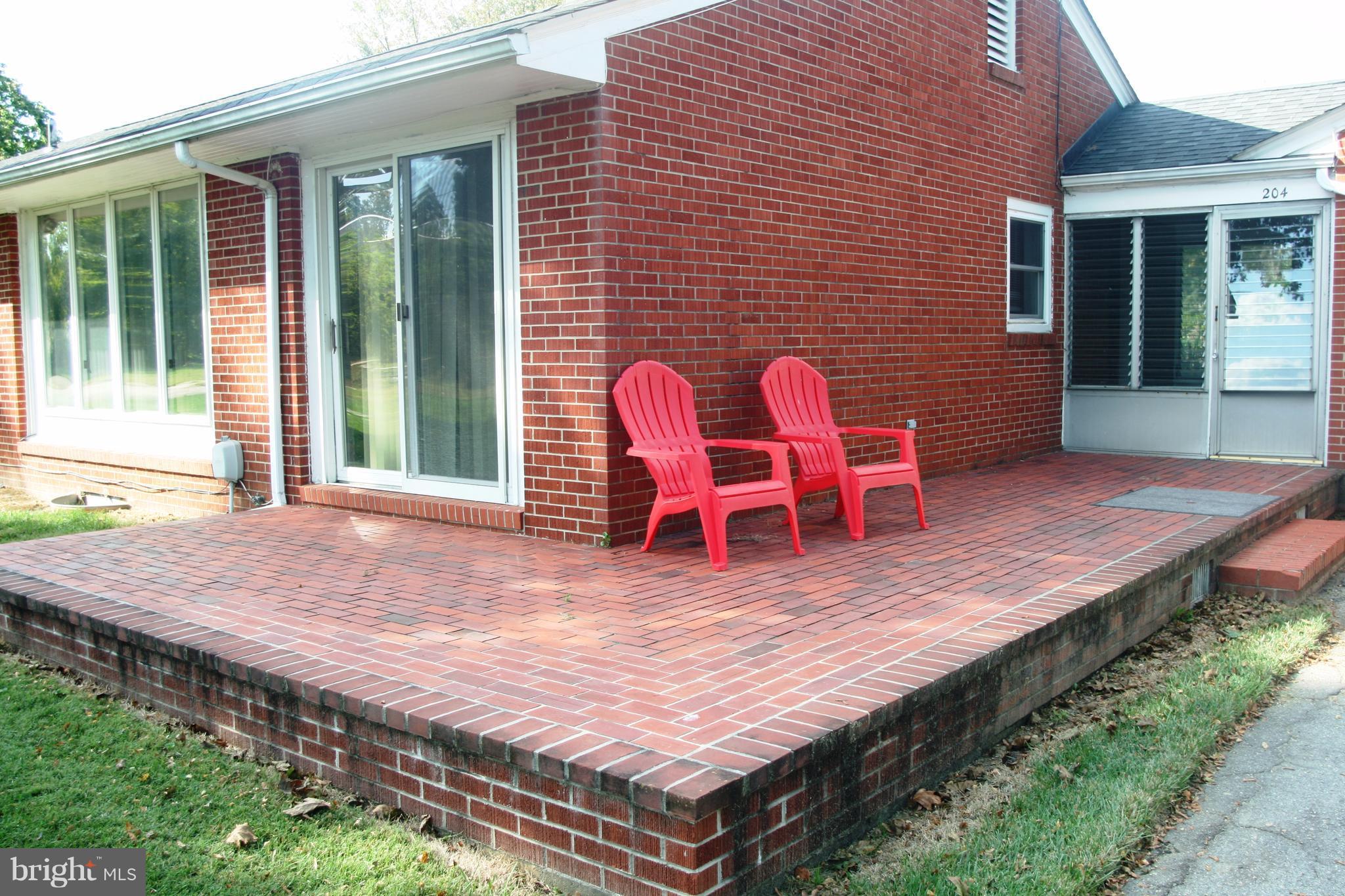 204 Valley Road Chestertown, MD 21620 - Photo 3 of 11 a wooden bench sitting in front of a house