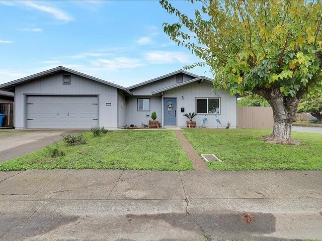 a front view of house with yard and green space