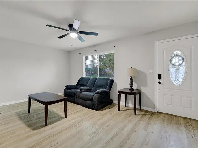 a living room with furniture and a wooden floor