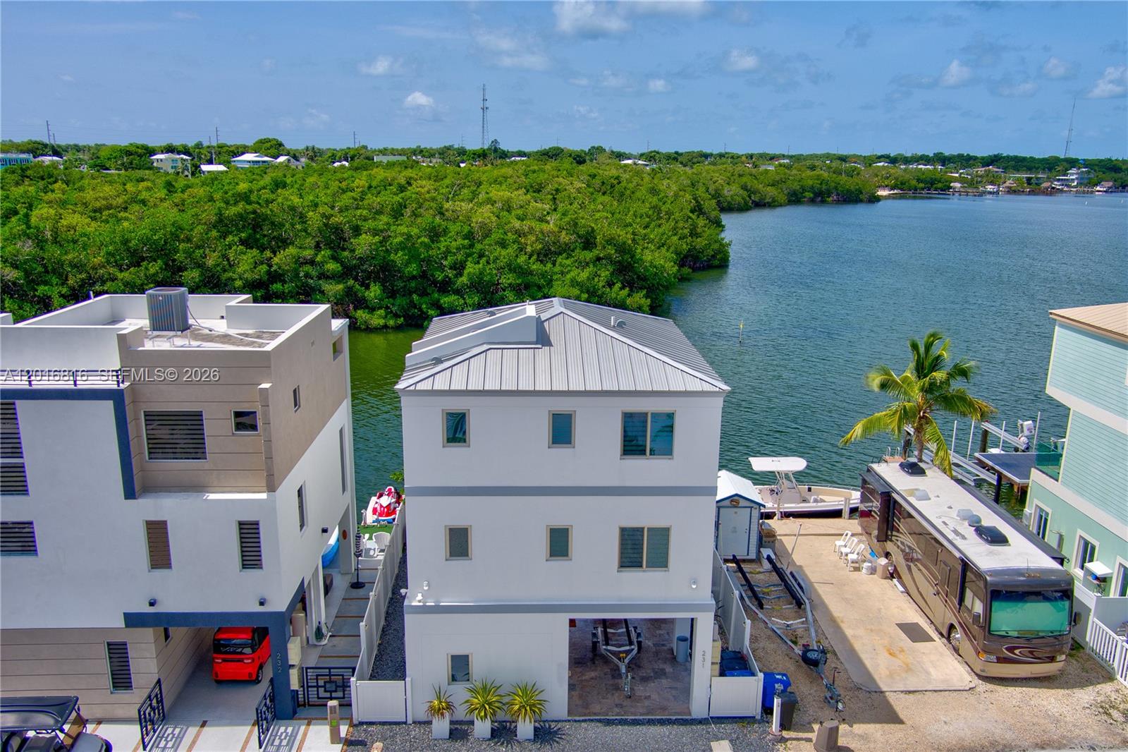 325 Calusa Key Largo, FL 33037 - Photo 1 of 32 a aerial view of a house with a yard and lake view
