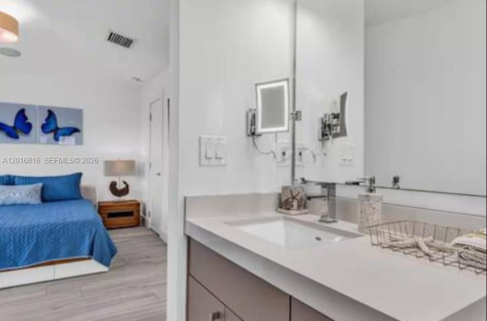 325 Calusa Key Largo, FL 33037 - Photo 14 of 32 a en suite bathroom with a double vanity sink and a mirror