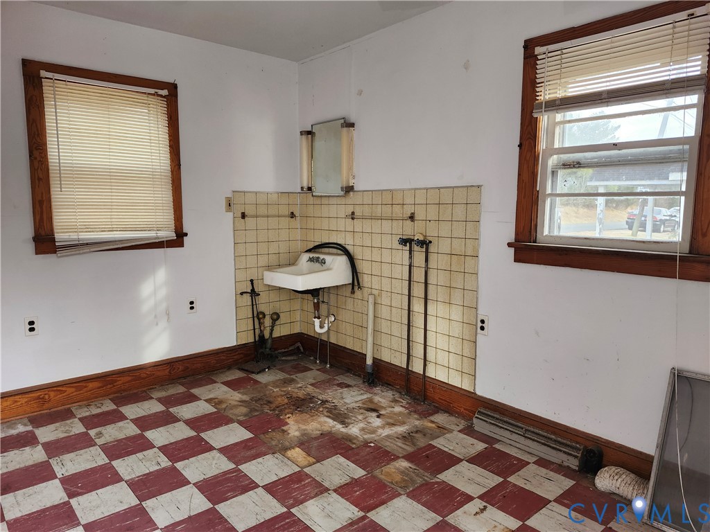 1801 Roberts Street Farmville, VA 23901 - Photo 2 of 6 a bathroom with a sink a toilet and a mirror