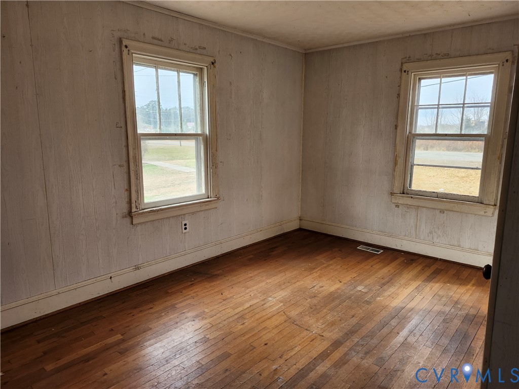 1801 Roberts Street Farmville, VA 23901 - Photo 5 of 6 an empty room with wooden floor and windows
