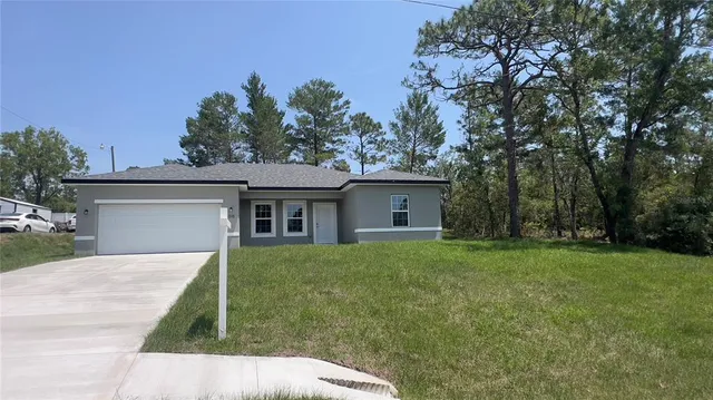 a front view of house with yard and trees