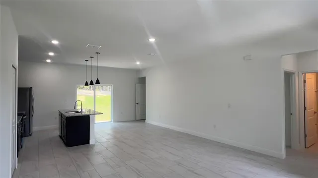 an empty room with a window and wooden floor