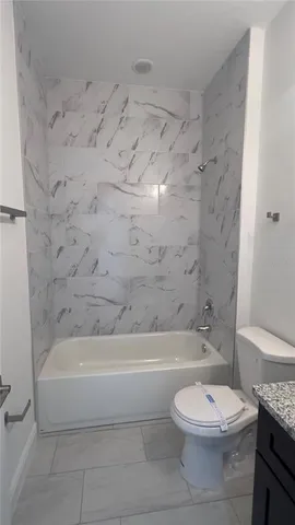 a bathroom with a toilet and a tub