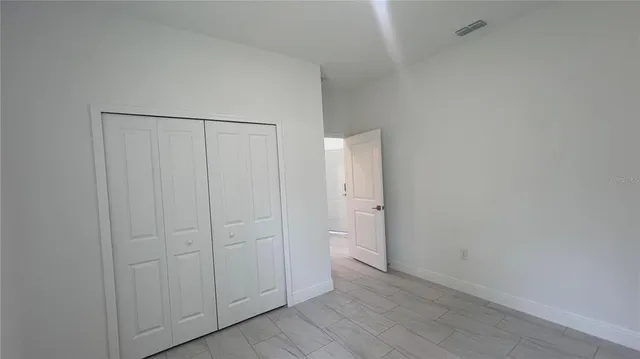 a bathroom with a granite countertop toilet a sink and a bathtub