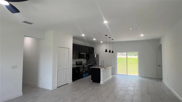 a kitchen with stainless steel appliances granite countertop a refrigerator and a sink